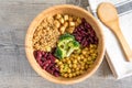 Vegan buddha bowl with stir fry tofu, brown rice, broccoli, red kidney beans, cooked chickpeas, seeds and vegetables. Royalty Free Stock Photo