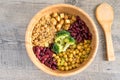 Vegan buddha bowl with stir fry tofu, brown rice, broccoli, red kidney beans, cooked chickpeas, seeds and vegetables. Royalty Free Stock Photo