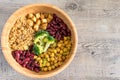 Vegan buddha bowl with stir fry tofu, brown rice, broccoli, red kidney beans, cooked chickpeas, seeds and vegetables. Royalty Free Stock Photo