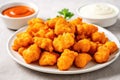 Vegan Buffalo Cauliflower Bites On White Round Plate On White Background. Generative AI Royalty Free Stock Photo