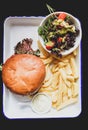 Vegan burger with salad, and french fries