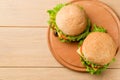 Vegan burgers with fresh vegetables on rustic wooden table, top view. Healthy fast food background with copy space Royalty Free Stock Photo