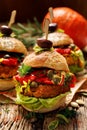 Vegan burgers, Pumpkin burgers with the addition of grilled peppers, lettuce, fresh herbs and capers Royalty Free Stock Photo