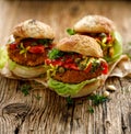 Vegan burgers, Pumpkin burgers with the addition of grilled peppers, lettuce, fresh herbs and capers Royalty Free Stock Photo