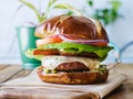 Vegan cheese burger on pretzal bun and meatless bacon Royalty Free Stock Photo