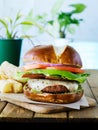 Vegan cheese burger on pretzal bun and meatless bacon Royalty Free Stock Photo