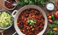 Vegan chilli con carne in bowl on wooden table, top view