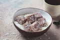 Vegan coconut and dates energy squares in coconut bowl