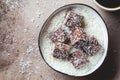 Vegan coconut and dates energy squares in coconut bowl