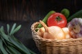 Vegan concept, healthy food, organic vegetables in a basket on a dark background, in a rustic style, the main object is Royalty Free Stock Photo