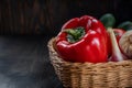 Vegan concept, healthy food, organic vegetables in a basket on a dark background, in a rustic style, the main object is Royalty Free Stock Photo