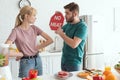 vegan couple with no meat sign at table with raw meat and vegetables in kitchen