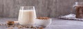 Vegan dairy-free buckwheat milk in a glass and cereals in a bowl on the table web banner