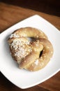 Vegan dairy-free organic german pretzel bread on wood table