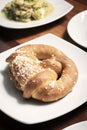 Vegan dairy-free organic german pretzel bread on wood table