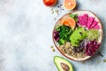 Vegan, detox Buddha bowl with quinoa, micro greens, avocado, blood orange, broccoli, watermelon radish, alfalfa seed sprouts. Royalty Free Stock Photo