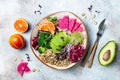 Vegan, detox Buddha bowl with quinoa, micro greens, avocado, blood orange, broccoli, watermelon radish, alfalfa seed sprouts. Royalty Free Stock Photo