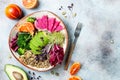 Vegan, detox Buddha bowl with quinoa, micro greens, avocado, blood orange, broccoli, watermelon radish, alfalfa seed sprouts. Royalty Free Stock Photo