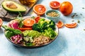 Vegan, detox Buddha bowl with vegetables, avocado, blood orange, broccoli, watermelon radish, spinach, quinoa, pumpkin seeds. Royalty Free Stock Photo
