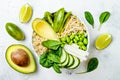 Vegan, detox green Buddha bowl recipe with quinoa, cucumber, broccoli, asparagus and sweet peas. Royalty Free Stock Photo