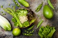 Vegan, detox green Buddha bowl recipe with quinoa, cucumber, broccoli, asparagus and sweet peas. Royalty Free Stock Photo