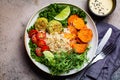 Vegan dinner. Quinoa salad with baked sweet potato, falafel, kale and pea seedlings. Falafel salad bowl, top view Royalty Free Stock Photo