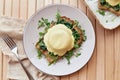 Vegan eggs benedict dish with sourdough bread, creamy plant-based hollandaise sauce, smoked tofu, young onion, parsley Royalty Free Stock Photo