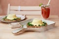 Vegan eggs benedict with plant-based sauce, sourdough bread, tofu, young onion, greens, pea sprouts. Healthy breakfast Royalty Free Stock Photo