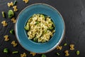 Vegan Farfalle pasta in a spinach sauce with broccoli, brussels sprouts, green beans in plate on dark stone background. Top view, Royalty Free Stock Photo