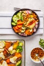 Vegan flat lay, Buddha bowl with baked vegetables, chickpeas, hummus and tofu. Royalty Free Stock Photo