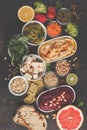 Vegan food background. Vegetarian snacks: hummus, beetroot hummus, green peas dip, vegetables, cereals, tofu. Top view, dark back Royalty Free Stock Photo