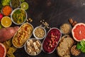 Vegan food background. Vegetarian snacks: hummus, beetroot hummus, green peas dip, vegetables, cereals, tofu. Top view, dark back Royalty Free Stock Photo