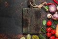 Vegan food cooking background. Fresh vegetables, mushrooms, spices and herbs with cutting board Royalty Free Stock Photo