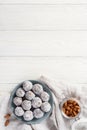 Vegan food energy balls with prunes, almond and coconut. White wooden background