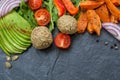 Vegan food frame: avocado, sweet potato, lentil cutlets, tomatoes