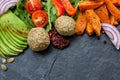 Vegan food frame: avocado, sweet potato, lentil cutlets, tomatoes