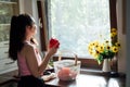 Vegan food and health. Vegans Eat. Young Latina woman holding red Bell pepper near vegetables on table in home kitchen. Royalty Free Stock Photo