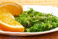 Vegan food. Japanese cuisine. Seaweed salad with orange in white plate Royalty Free Stock Photo