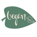 Vegan food logo, icon. Veganism banner. Hand lettering against a background of a green leaf