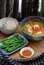 Vegan food menu with boiled peas, bowl of okra, tomato, tofu soup and rice