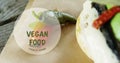 Vegan food text banner against close up of a food item