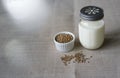 Vegan fresh milk from hemp seeds in a glass jar, clean eating, non-dairy milk. Backround from linen Royalty Free Stock Photo