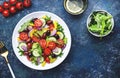 Vegan greek salad with kalamata olives, red tomato, yellow paprika, cucumber and onion, healthy mediterranean diet food, low