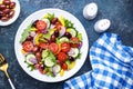 Vegan greek salad with kalamata olives, red tomato, yellow paprika, cucumber and onion, healthy mediterranean diet food, low