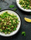 Vegan Green broad beans and quinoa salad with sweet peas and mint. Healthy food. Royalty Free Stock Photo