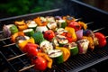 Vegan grilled shashlik with bell peppers, zucchini and mushrooms on barbecue