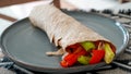 Vegan grilled vegetable wrap on gray plate Royalty Free Stock Photo