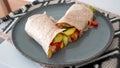 Vegan grilled vegetable wrap on gray plate Royalty Free Stock Photo