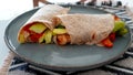 Vegan grilled vegetable wrap on gray plate Royalty Free Stock Photo