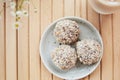 Vegan handmade delight - gluten and sugar free natural balls sweets and coffee on the wooden table close up. Healthy Royalty Free Stock Photo